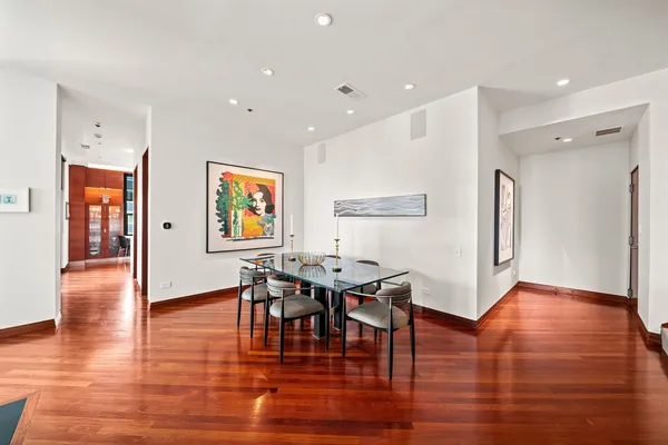 a view of a a dining room with furniture and wooden floor