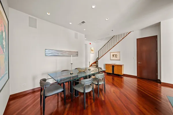 a dining room with furniture and wooden floor