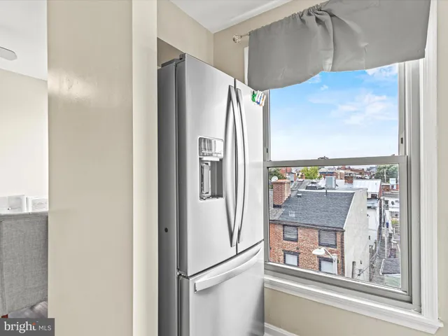 a kitchen with stainless steel appliances granite countertop a refrigerator and a more cabinets