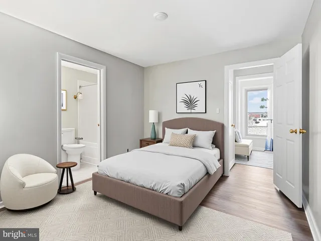 a spacious bedroom with a bed and a couch