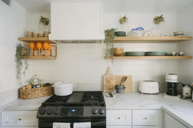 a kitchen with a stove and cabinets