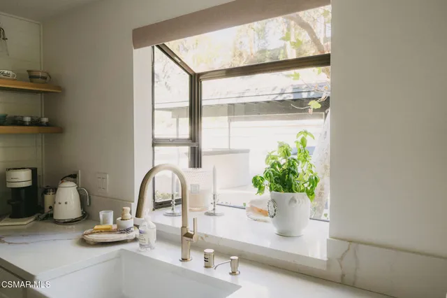 a close view of a faucet a sink and a window