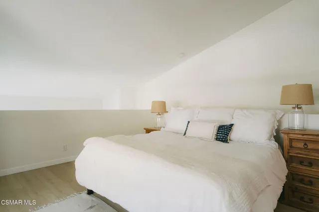 a bedroom with a bed and a night stand