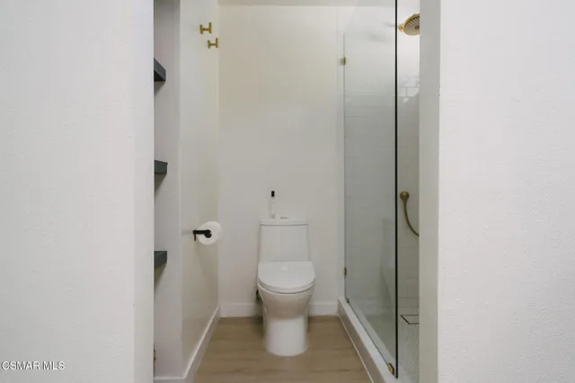 a bathroom with a toilet and a shower