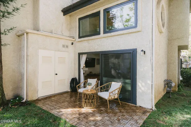 a view of a porch with chairs and backyard