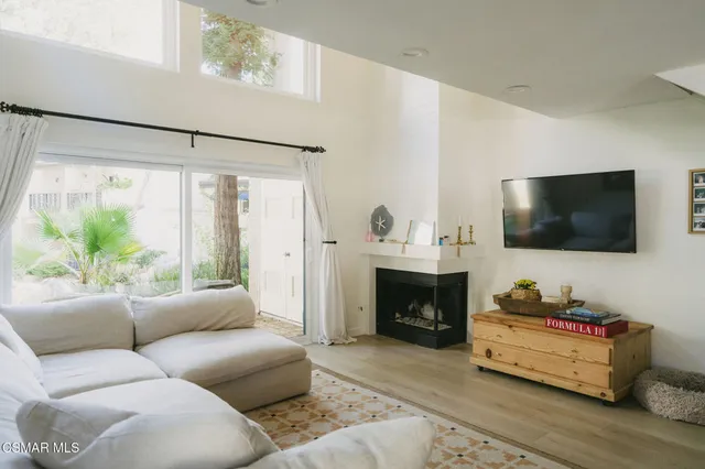 a living room with furniture flat screen tv and a fireplace