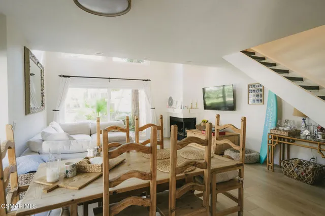a dinning room with furniture and wooden floor