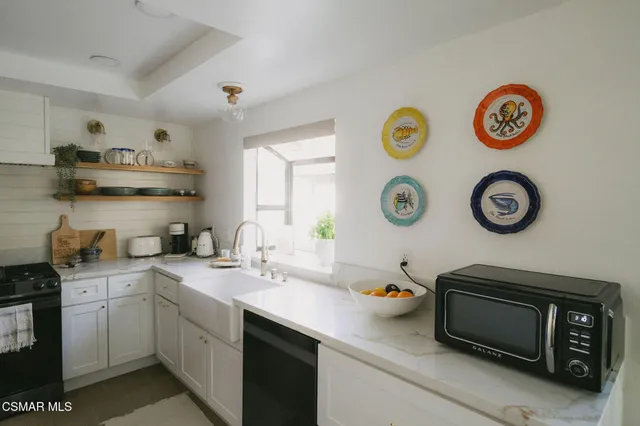 a kitchen with a sink and a stove top oven