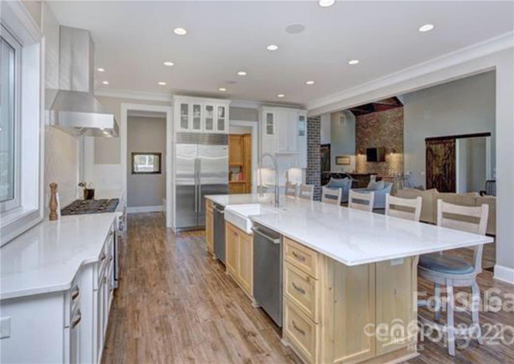 2188 Bessbrook Road Fort Mill, SC 29708 - Photo 5 of 48 a kitchen with stainless steel appliances kitchen island granite countertop a table chairs and a refrigerator