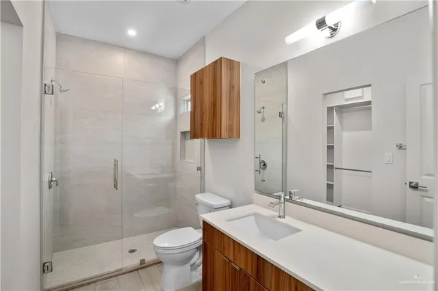 a bathroom with a sink toilet and shower