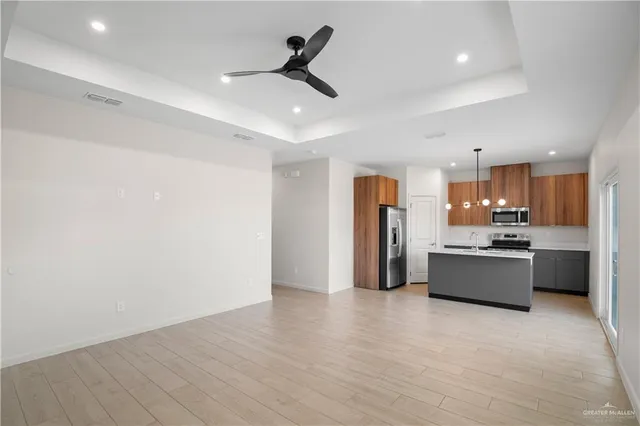a large kitchen with a lot of counter space and stainless steel appliances