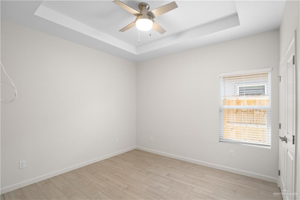 3416 Duke Avenue, Unit 3 McAllen, TX 78504 - Photo 9 of 15 an empty room with a window and a fan