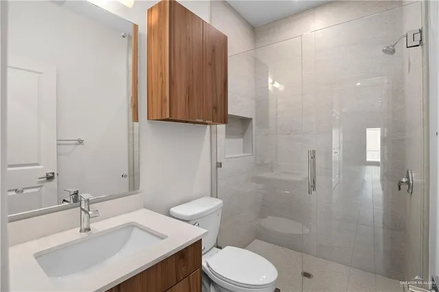 a bathroom with a sink toilet and shower