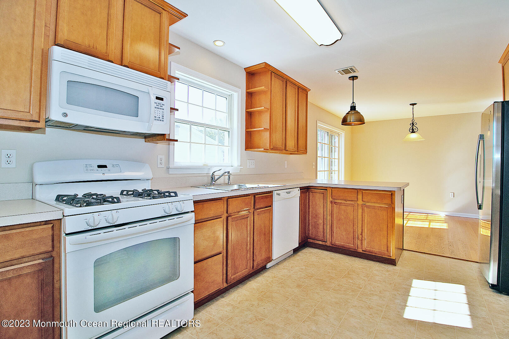 2117 Whitcomb Road Forked River, NJ 08731 - Photo 16 of 49 a kitchen with stainless steel appliances granite countertop a stove a sink and a refrigerator