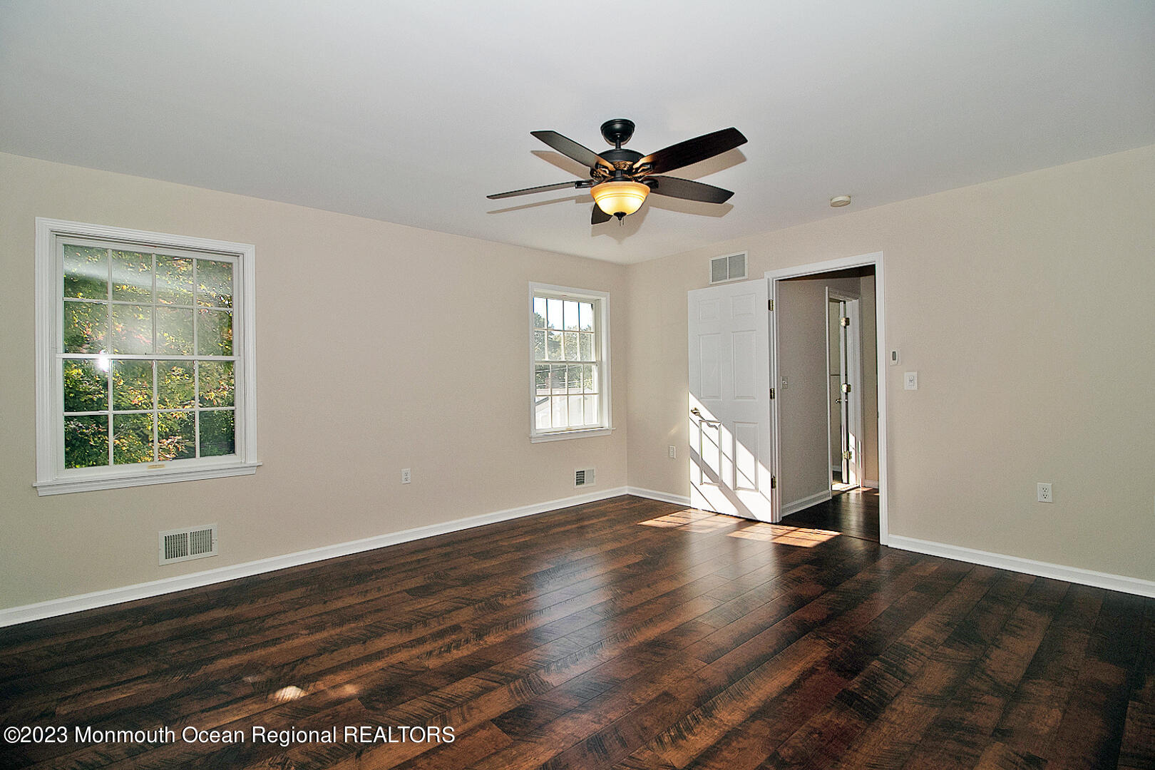 2117 Whitcomb Road Forked River, NJ 08731 - Photo 23 of 49 a view of an empty room with wooden floor and a window