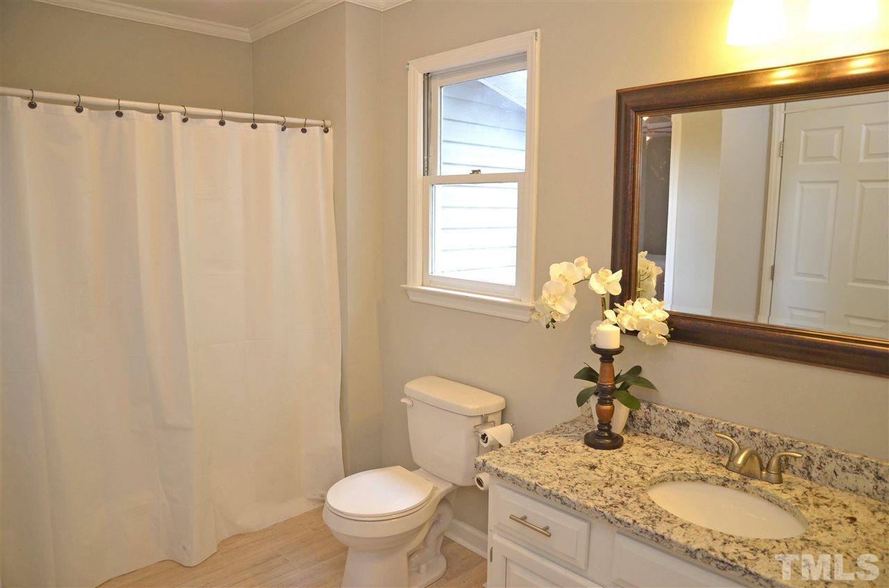3913 Iron Horse Road Raleigh, NC 27616 - Photo 15 of 20 a bathroom with a granite countertop sink toilet and a mirror