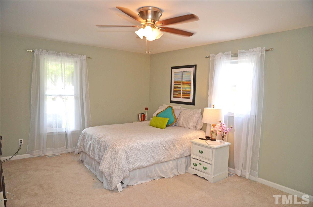3913 Iron Horse Road Raleigh, NC 27616 - Photo 16 of 20 a bedroom with a bed and a chandelier fan