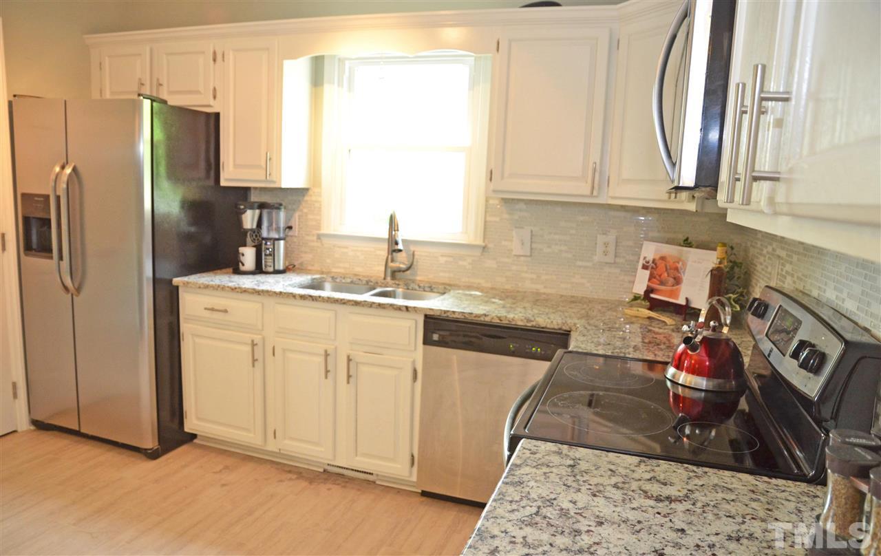 3913 Iron Horse Road Raleigh, NC 27616 - Photo 6 of 20 a kitchen with stainless steel appliances granite countertop a sink stove and refrigerator