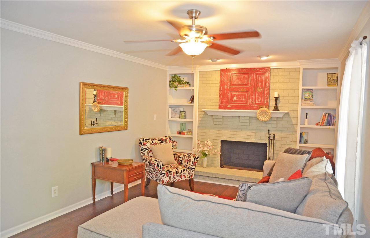 3913 Iron Horse Road Raleigh, NC 27616 - Photo 9 of 20 a living room with furniture a fireplace and a ceiling fan