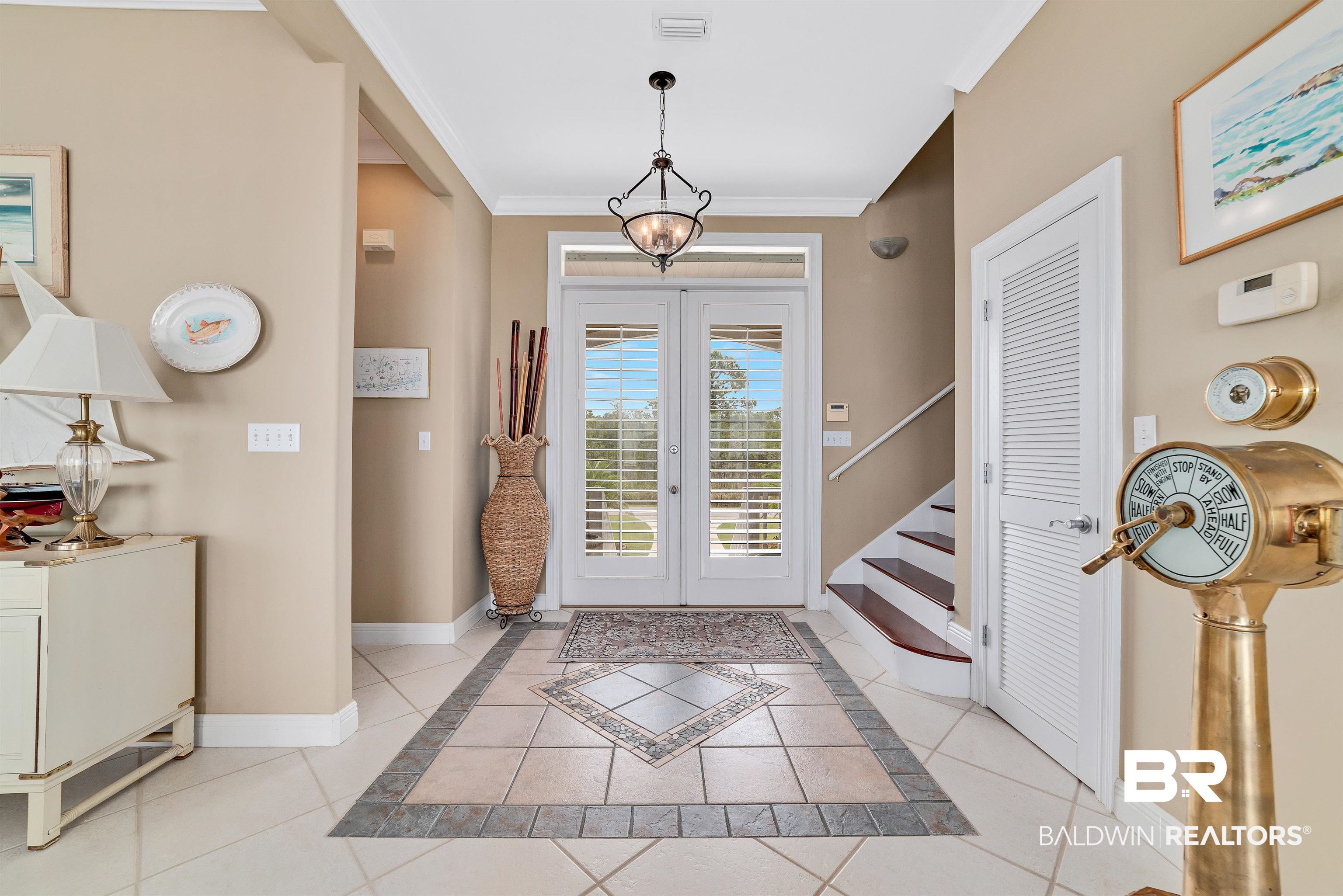 24513 Gulf Bay Road Orange Beach, AL 36561 - Photo 3 of 52 Tiled entryway featuring crown molding and french doors