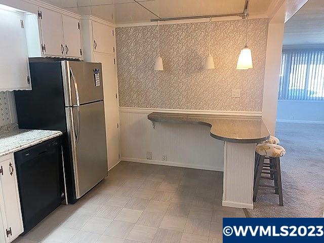 4940 Sunnyside Road Southeast, Unit F3 Salem, OR 97302 - Photo 6 of 18 a view of a refrigerator in kitchen and an empty room