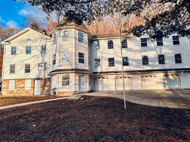 a view of a white house with large windows