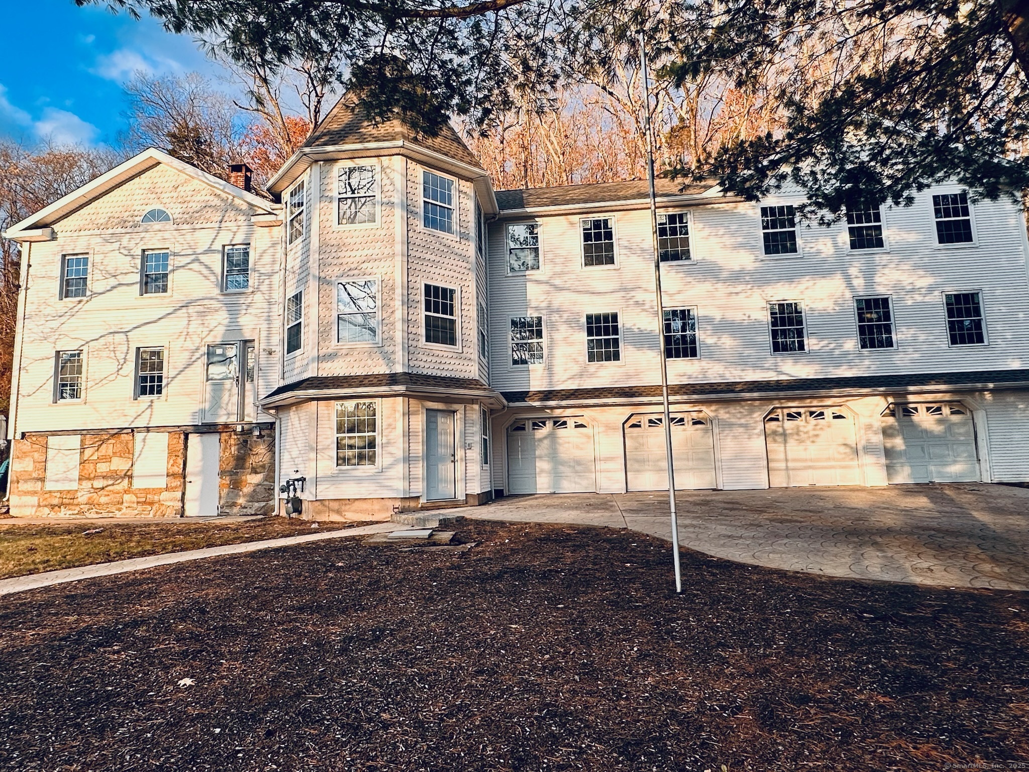 a view of a white house with large windows