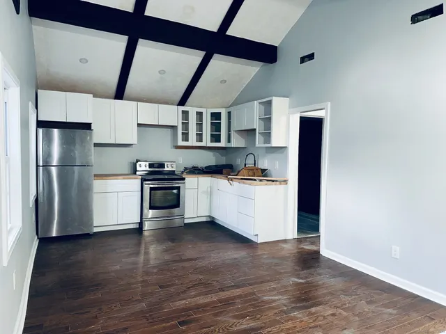 a kitchen with stainless steel appliances a refrigerator and a stove top oven