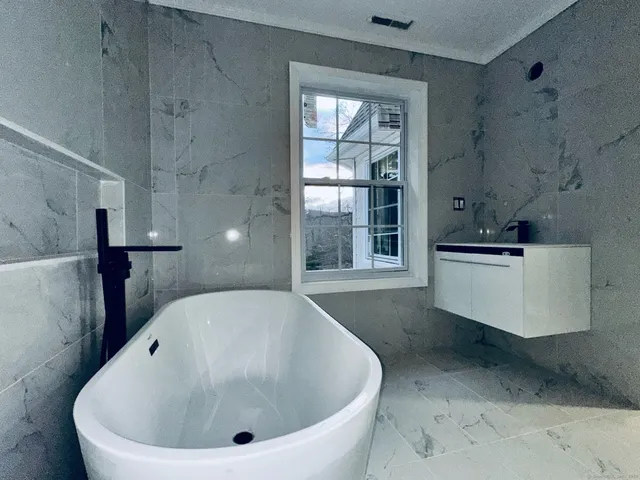 a white bath tub sitting in a bathroom