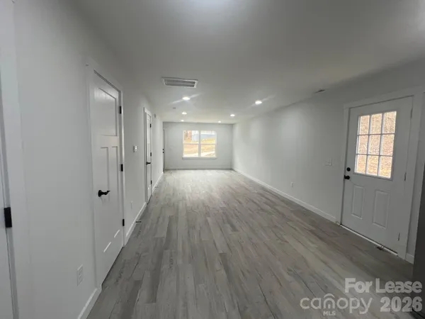 a view of hallway with wooden floor