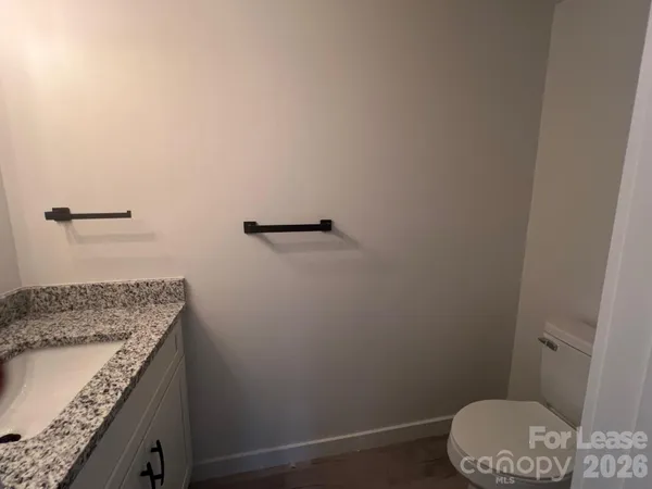 a bathroom with a granite countertop sink and vanity