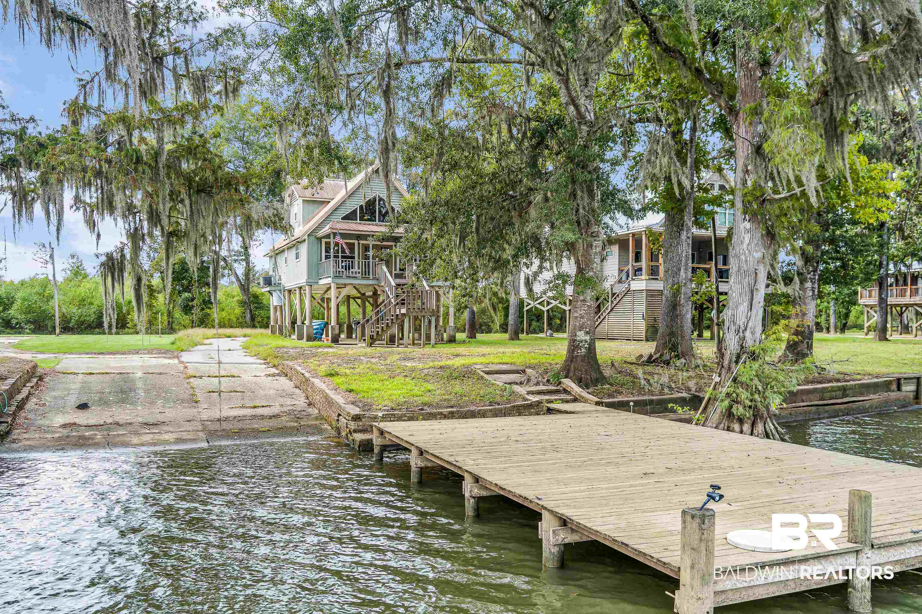 8317 Bryant's Lndg Road Stockton, AL 36579 - Photo 6 of 28 Dock featuring a water view, stairs, a boat ramp, and a yard