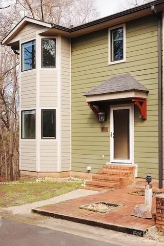 a view of a house with a small backyard