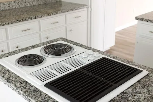 a close view of a stove and utility room