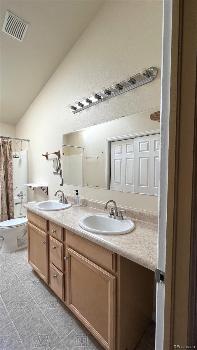 303 Virginia Road, Unit E Bailey, CO 80421 - Photo 11 of 16 a bathroom with a granite countertop sink and a mirror