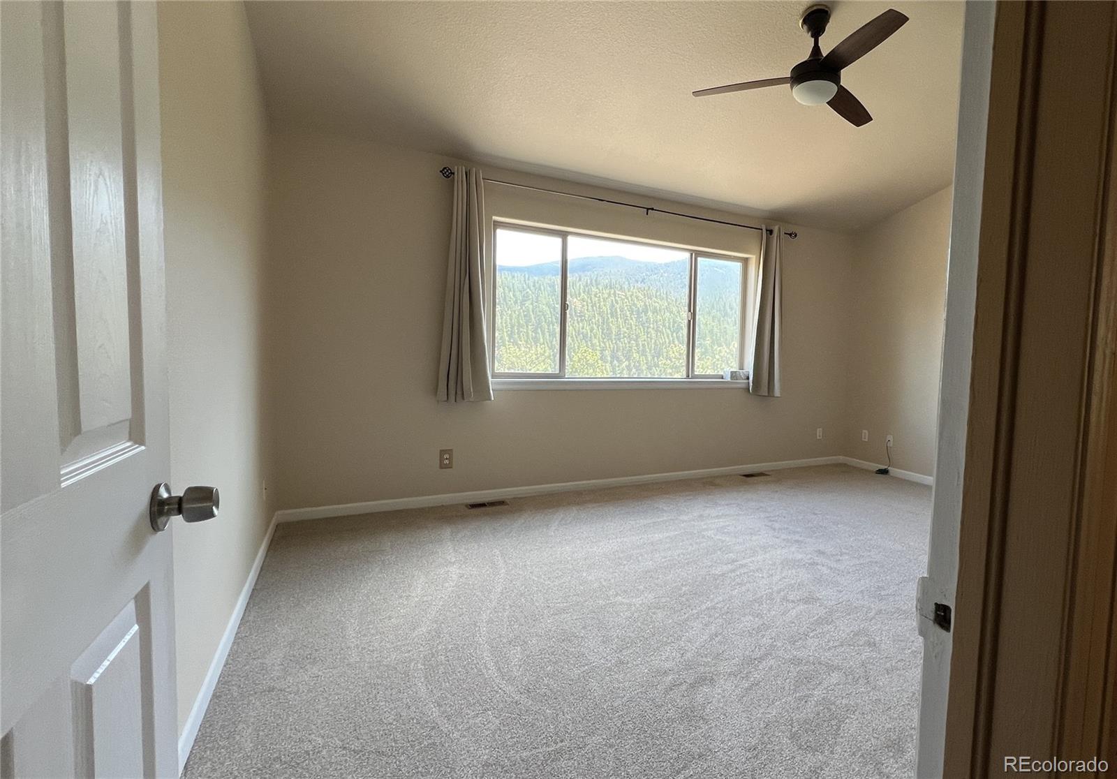 303 Virginia Road, Unit E Bailey, CO 80421 - Photo 13 of 16 an empty room with a window