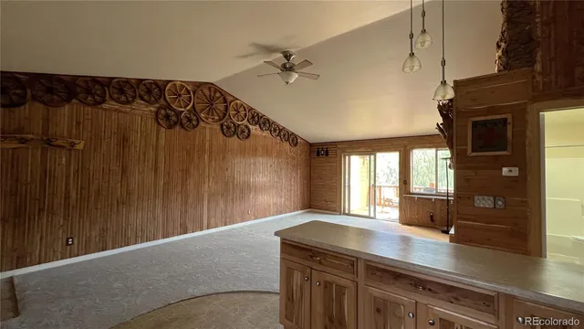 a kitchen with a refrigerator and countertop cabinets