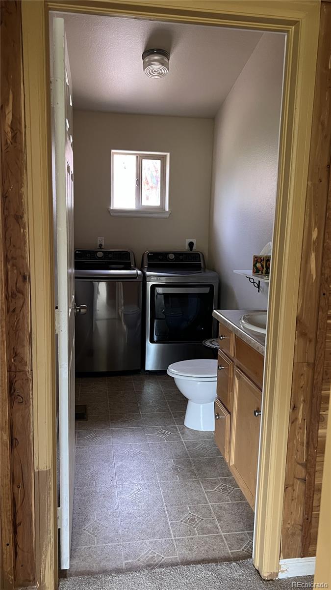 303 Virginia Road, Unit E Bailey, CO 80421 - Photo 7 of 16 a kitchen with a refrigerator and a stove