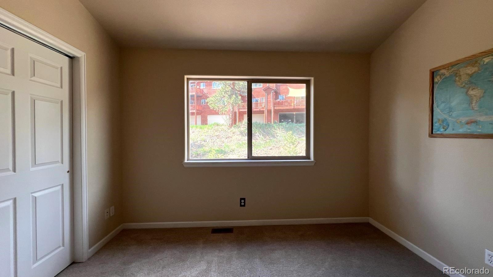 303 Virginia Road, Unit E Bailey, CO 80421 - Photo 9 of 16 an empty room with a window