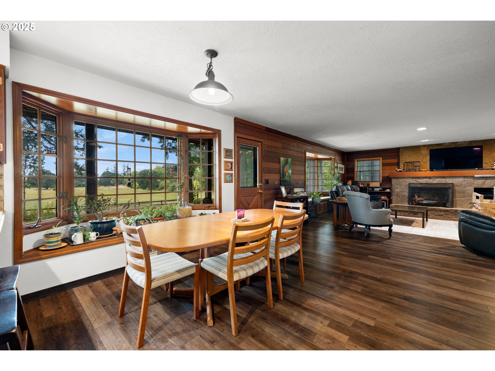 26465 Northwest West Union Road Hillsboro, OR 97124 - Photo 12 of 38 a dining room with furniture a chandelier and wooden floor