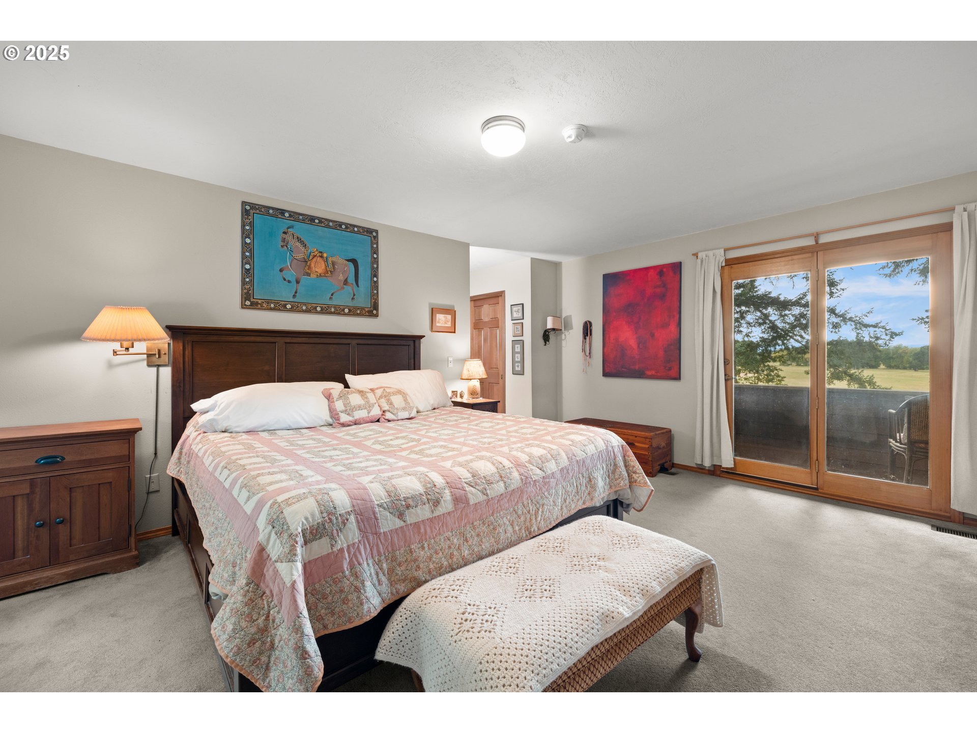 26465 Northwest West Union Road Hillsboro, OR 97124 - Photo 17 of 38 a bedroom with a bed and a chandelier