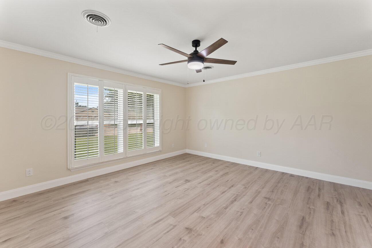 7204 Southwest 39th Avenue Amarillo, TX 79109 - Photo 27 of 51 a view of empty room with wooden floor and fan