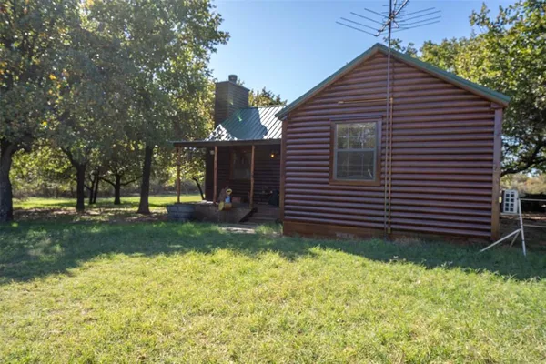 a backyard of a house with large trees