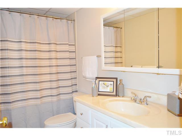 2405 Countrywood Road Raleigh, NC 27615 - Photo 17 of 25 The basement has a full bath. The tub has a tile surround and the floors are tile. Bathroom