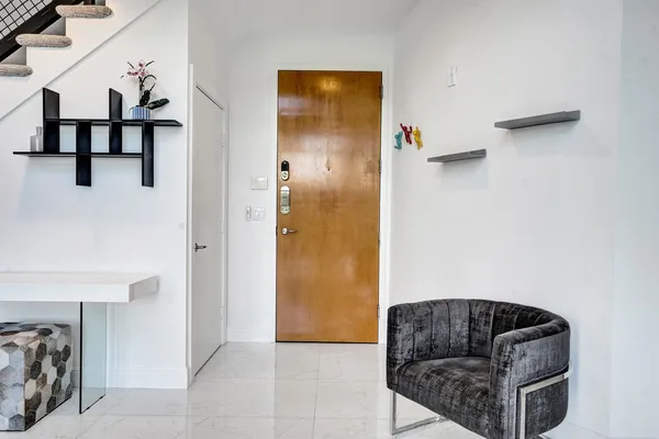 a kitchen with stainless steel appliances kitchen island granite countertop a refrigerator and a sink