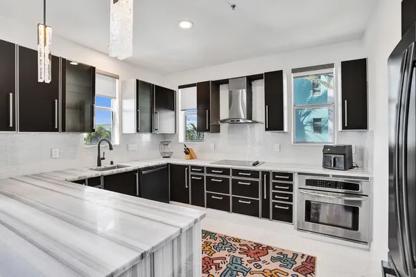 a kitchen with stainless steel appliances a stove sink and cabinets