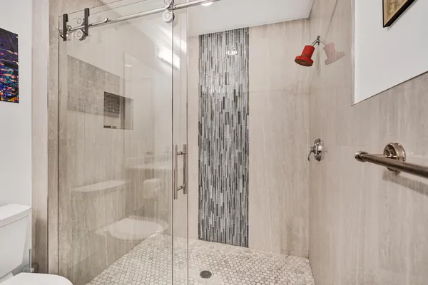 a bathroom with a granite countertop sink a toilet and a bathtub
