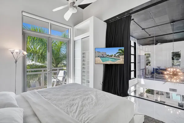 a bedroom with a bed dresser and a window
