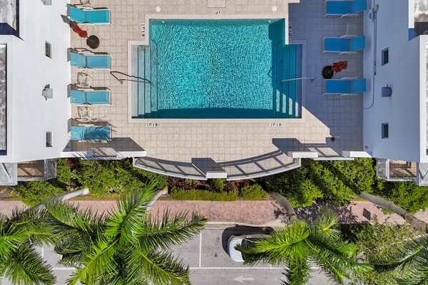 an aerial view of a house with a yard basket ball court and outdoor seating