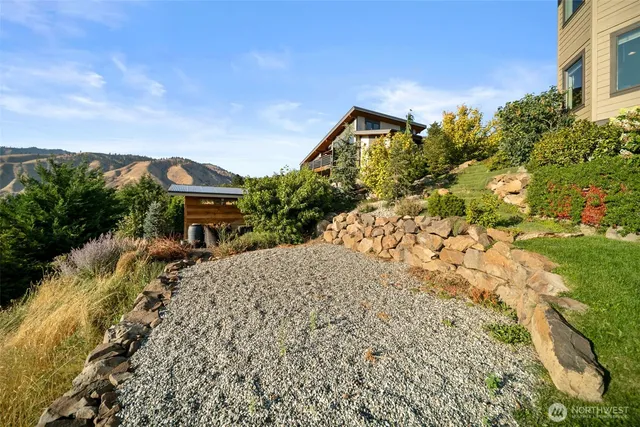 a view of a house with a yard and sitting area
